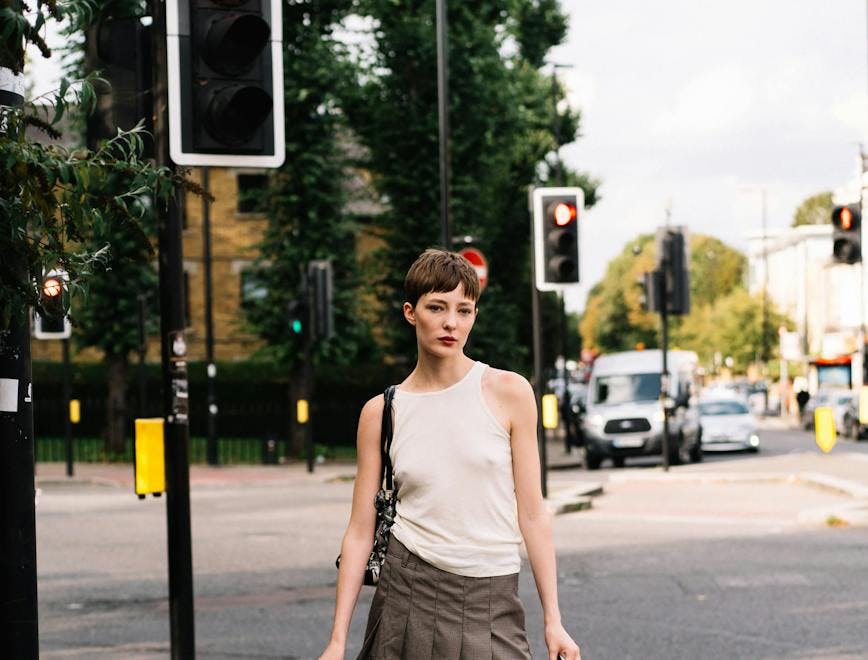 clothing skirt person light traffic light accessories bag handbag pedestrian